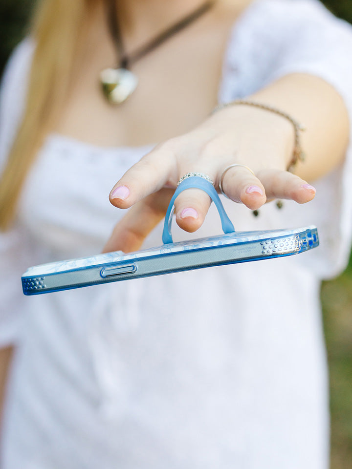 A woman holding a Blue Toile Loopy Case.|| feature-media