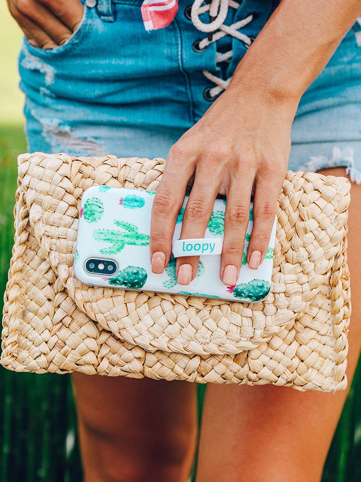A woman holding a Cactus Loopy Case.|| feature-media