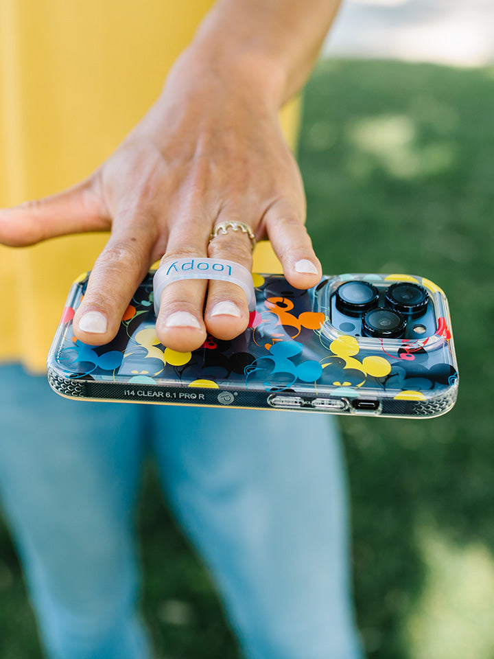 A woman holding a Colorful Mickeys Loopy Case.|| feature-media
