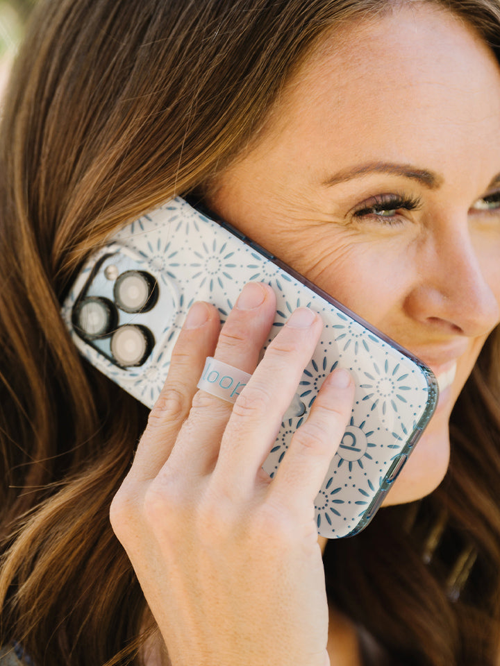 A woman holding a Talavera Loopy Case.|| feature-media