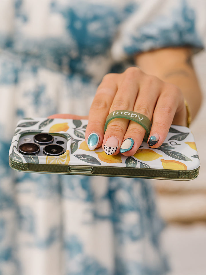 A woman holding a Lemon Grove Loopy Case. || feature-media