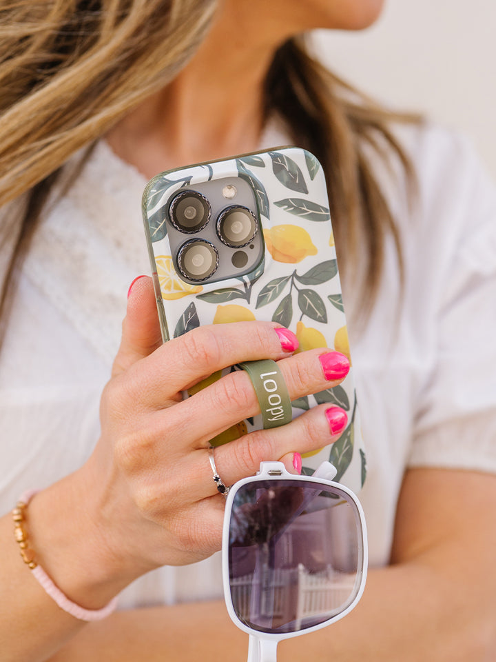 A woman holding a Lemon Grove Loopy Case. || feature-media
