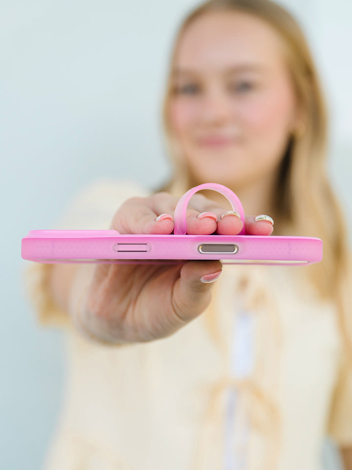 A woman holding a Berry Pink Loopy Case. || feature-media
