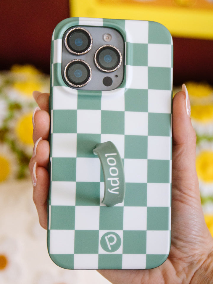 A woman holding a Green Checkered Loopy Case. || feature-media