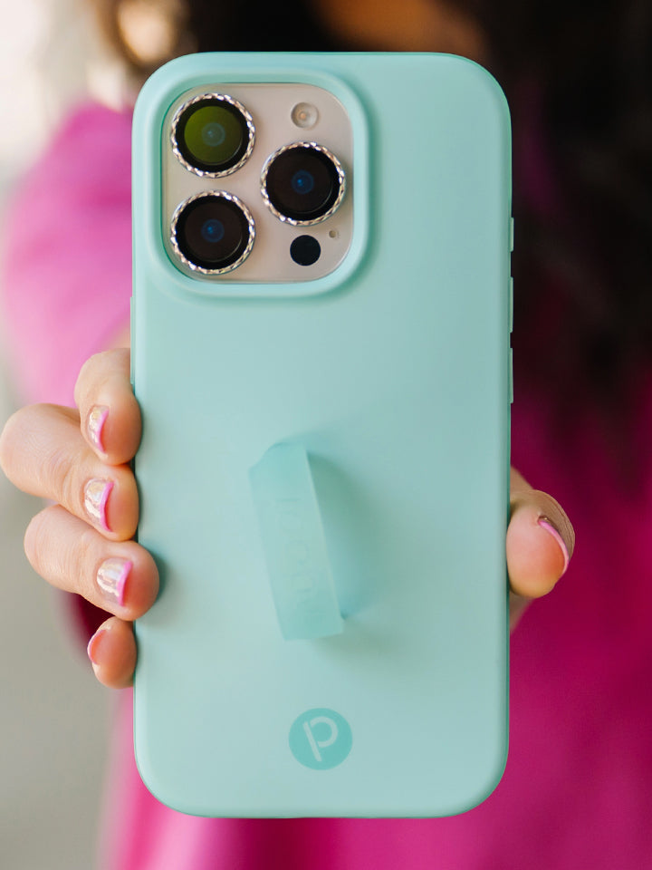A woman holding a Mint Splash Loopy Case. || feature-media