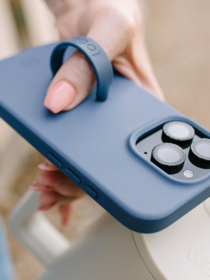A woman holding a Denim Loopy Case. || feature-media