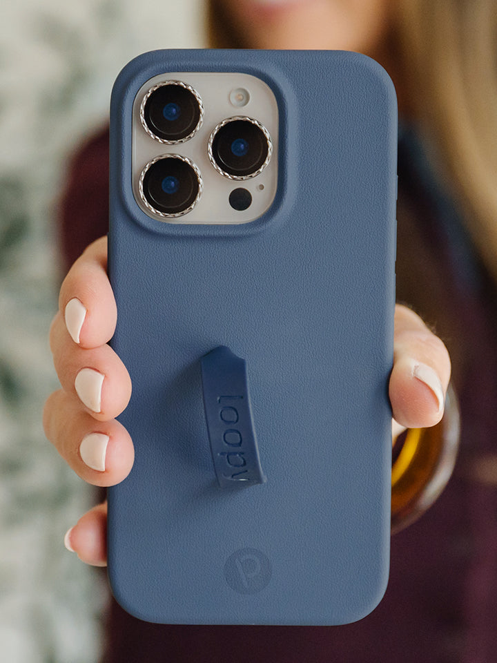 A woman holding a Denim Loopy Case. || feature-media