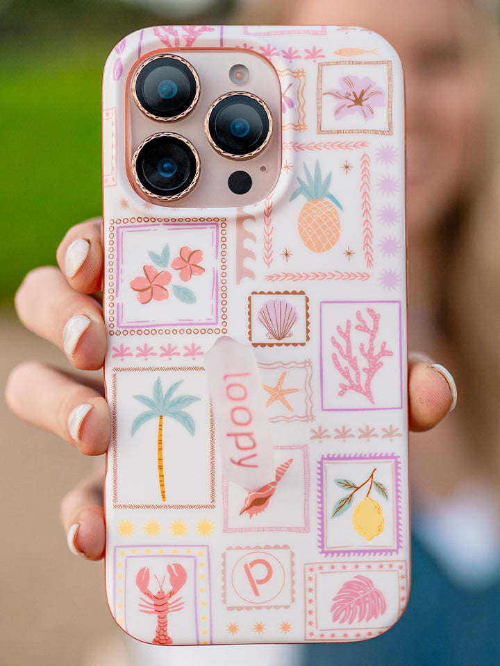 A woman holding a Seaside Stamps Loopy Case. || feature-media