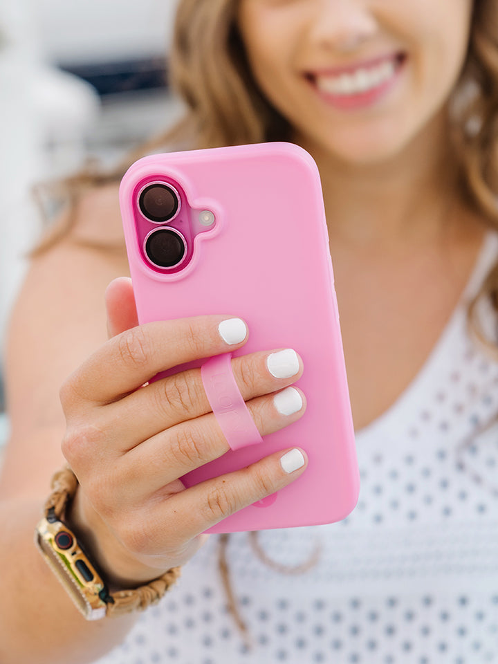 A woman holding a Berry Pink Loopy Case. || feature-media