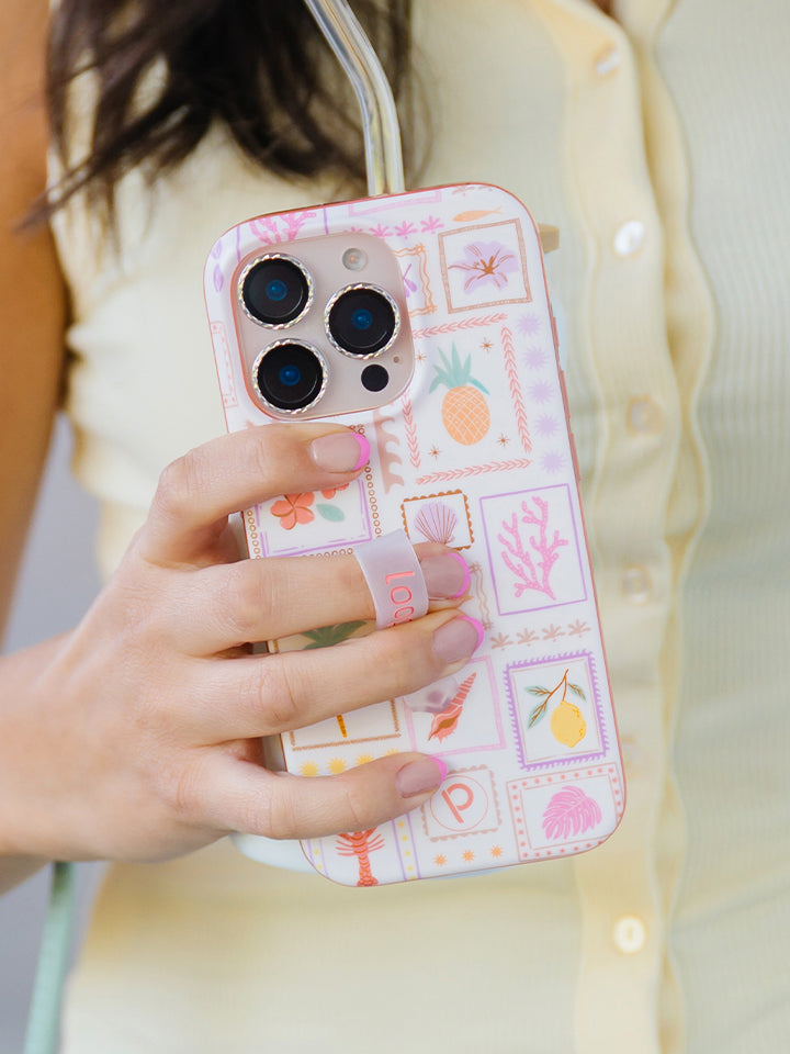 A woman holding a Seaside Stamps Loopy Case. || feature-media