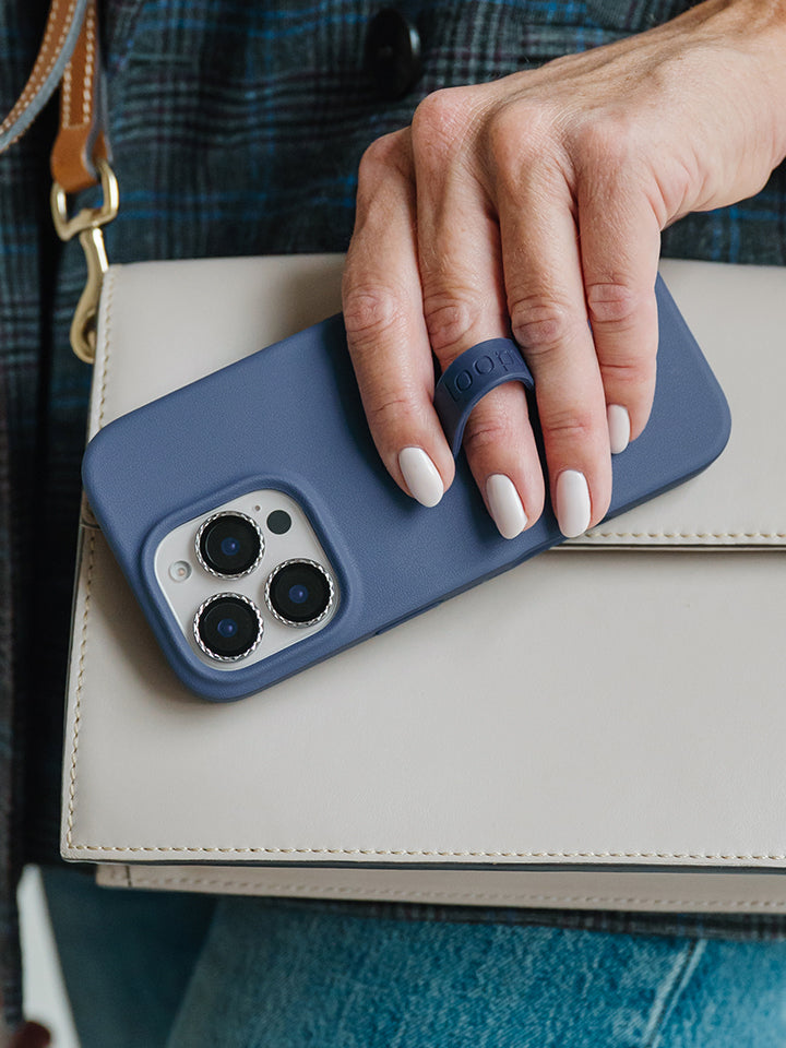 A woman holding a Denim Loopy Case. || feature-media
