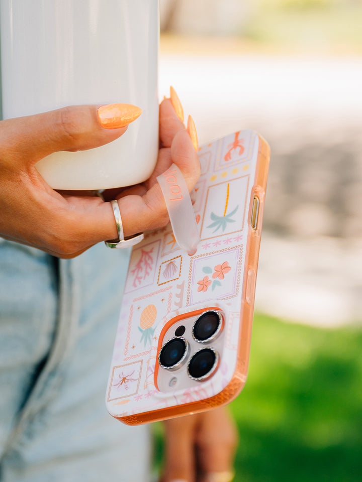 A woman holding a Seaside Stamps Loopy Case. || feature-media