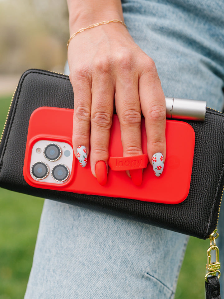 A woman holding a Red Loopy Case. || feature-media