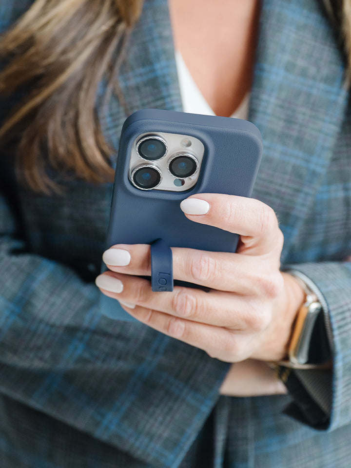 A woman holding a Denim Loopy Case. || feature-media