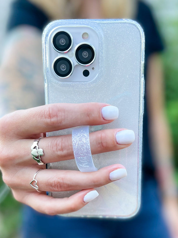 A woman holding a Clear Sparkle Silver Loopy Case.|| feature-media
