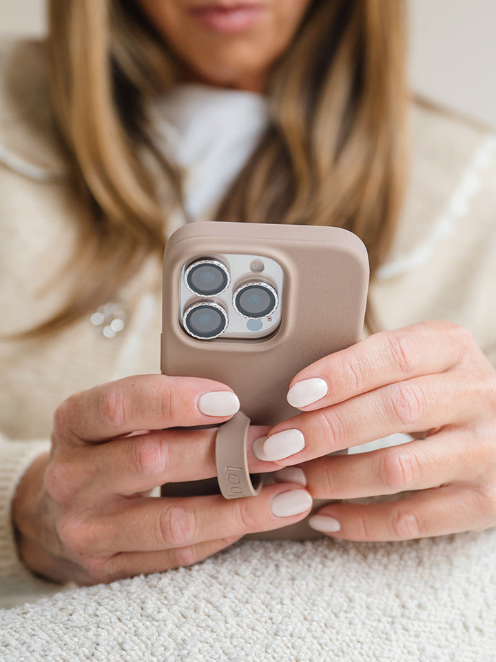 A woman holding a Stone Loopy Case. || feature-media