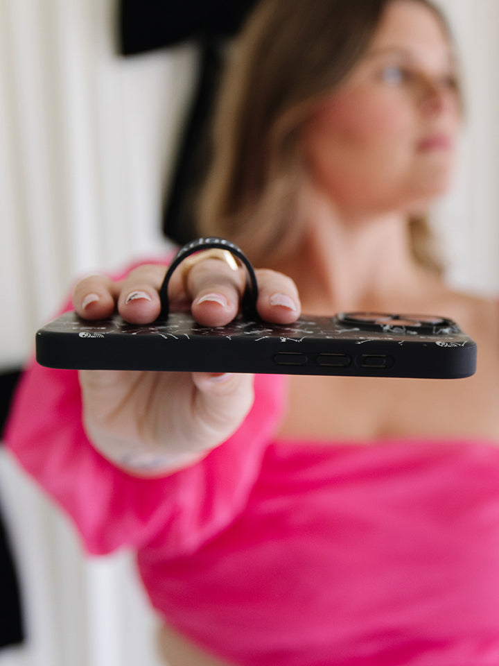 A woman holding a Boogie Bones Loopy Case. || feature-media