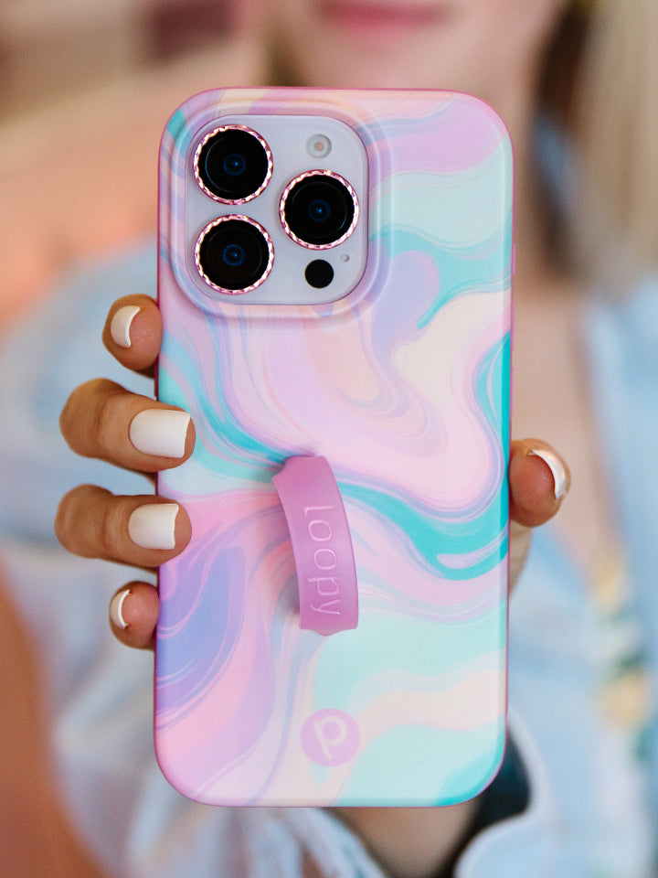 A woman holding a Sherbet Swirl Loopy Case. || feature-media