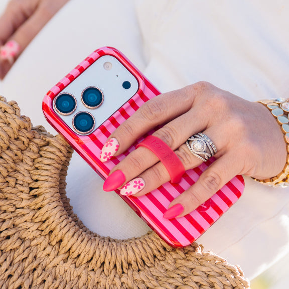 A photo of a woman holding a Berry Stripes Loopy Case