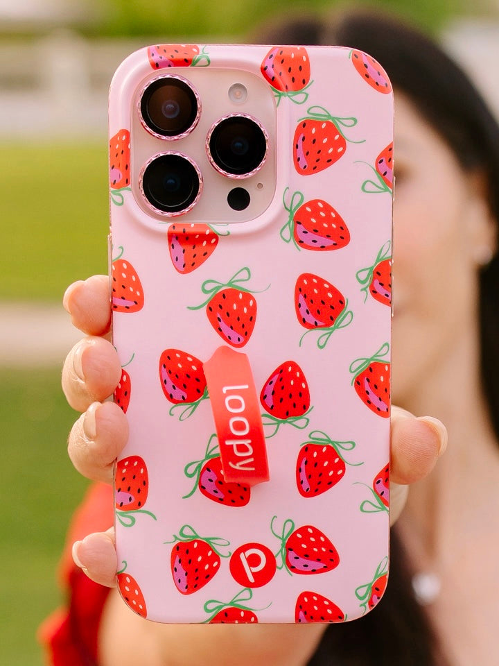 A woman holding a Berries and Bows Loopy Case. || feature-media