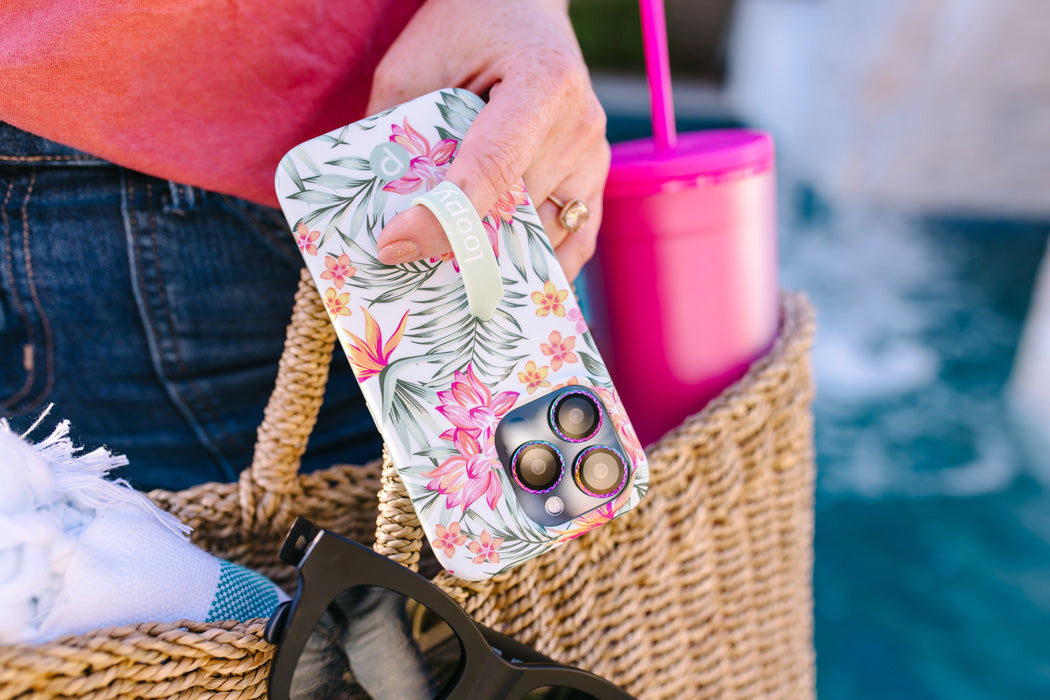 A woman holding a Tropical Blooms Loopy Case.