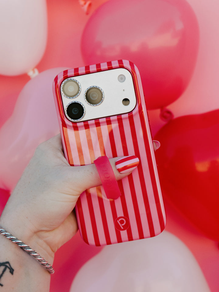 A woman holding a Berry Stripes Loopy Case. || feature-media