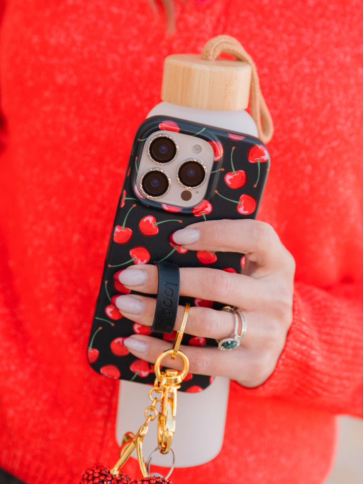 A woman holding a Black Cherry Loopy Case. || feature-media