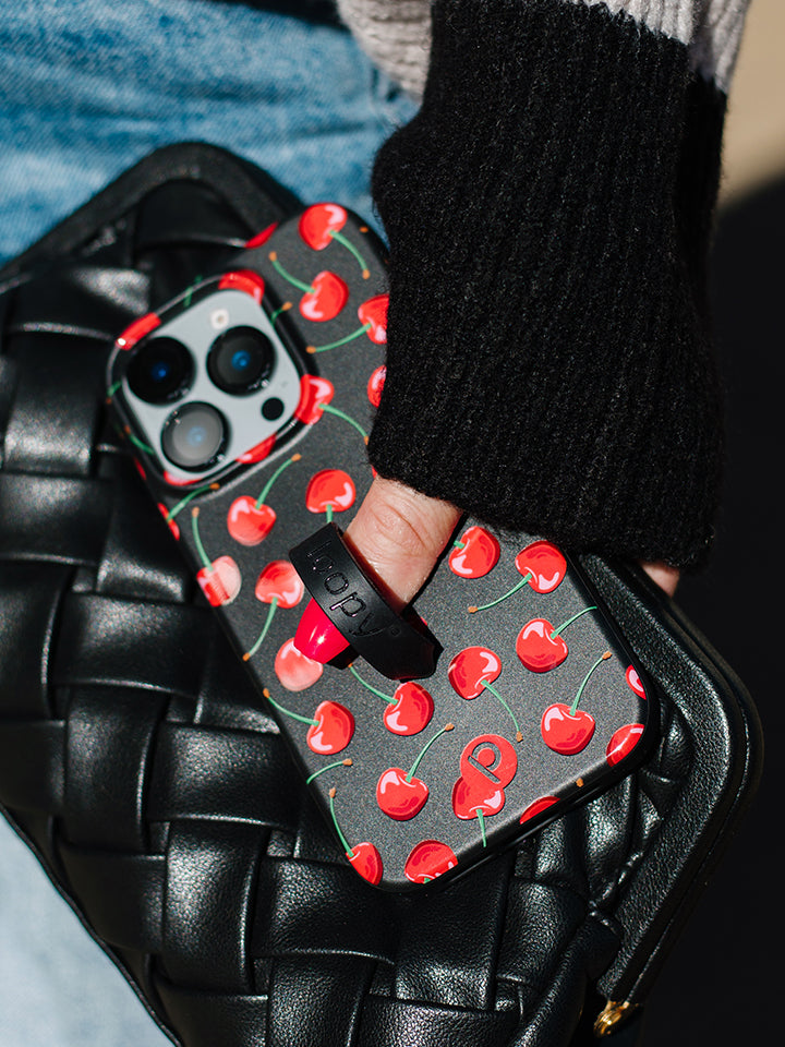 A woman holding a Black Cherry Loopy Case. || feature-media