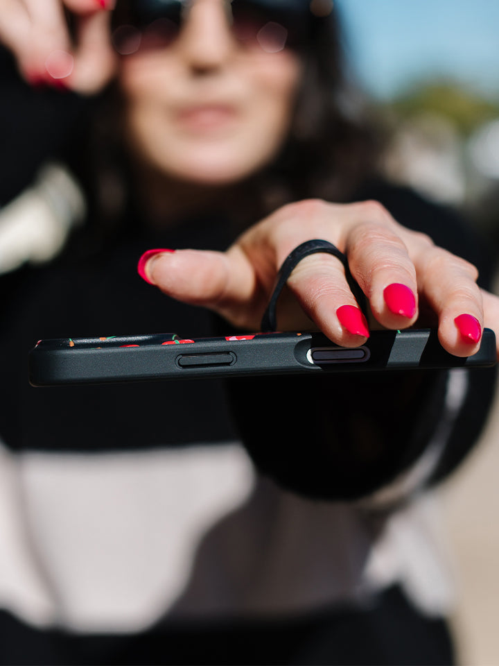 A woman holding a Black Cherry Loopy Case. || feature-media