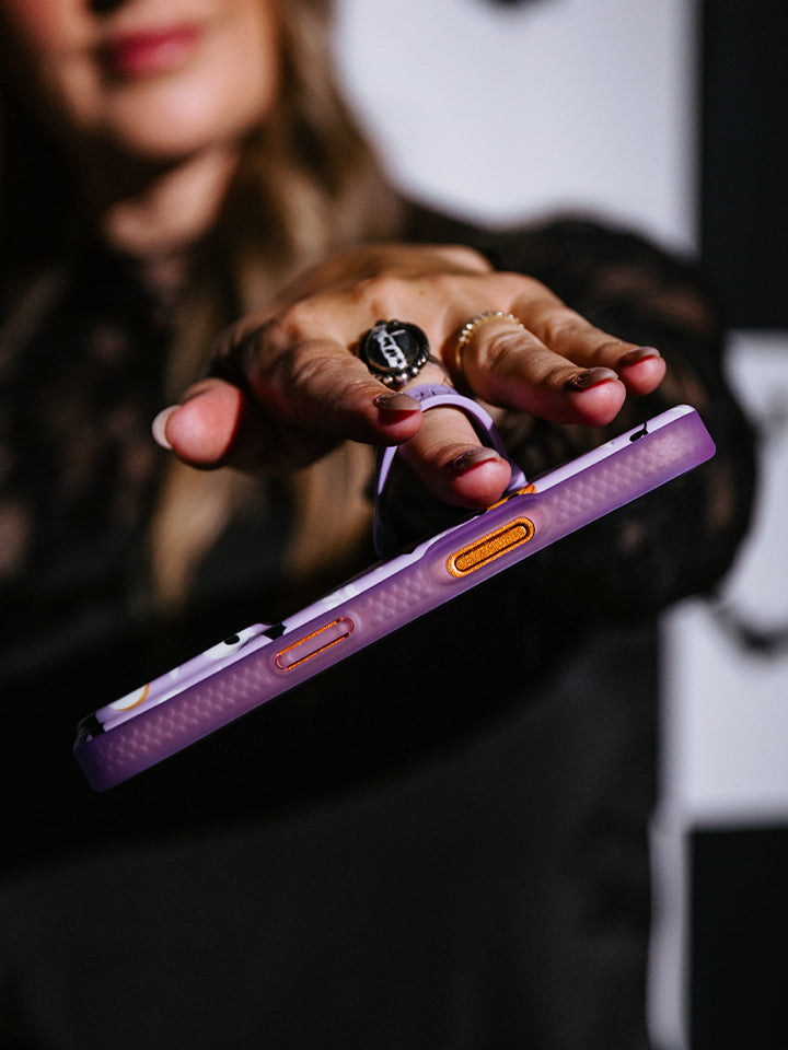 A woman holding a Boo Crew Loopy Case. || feature-media