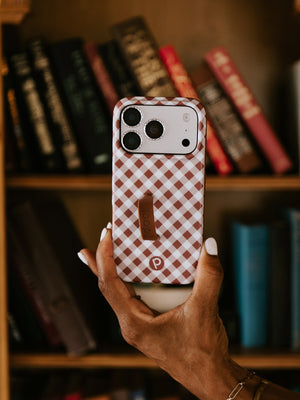 A woman holding a Brown Gingham Loopy Case.|| feature-media