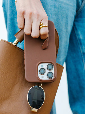 A woman holding a Cappuccino Loopy Case. || feature-media