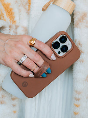 A woman holding a Cappuccino Loopy Case. || feature-media