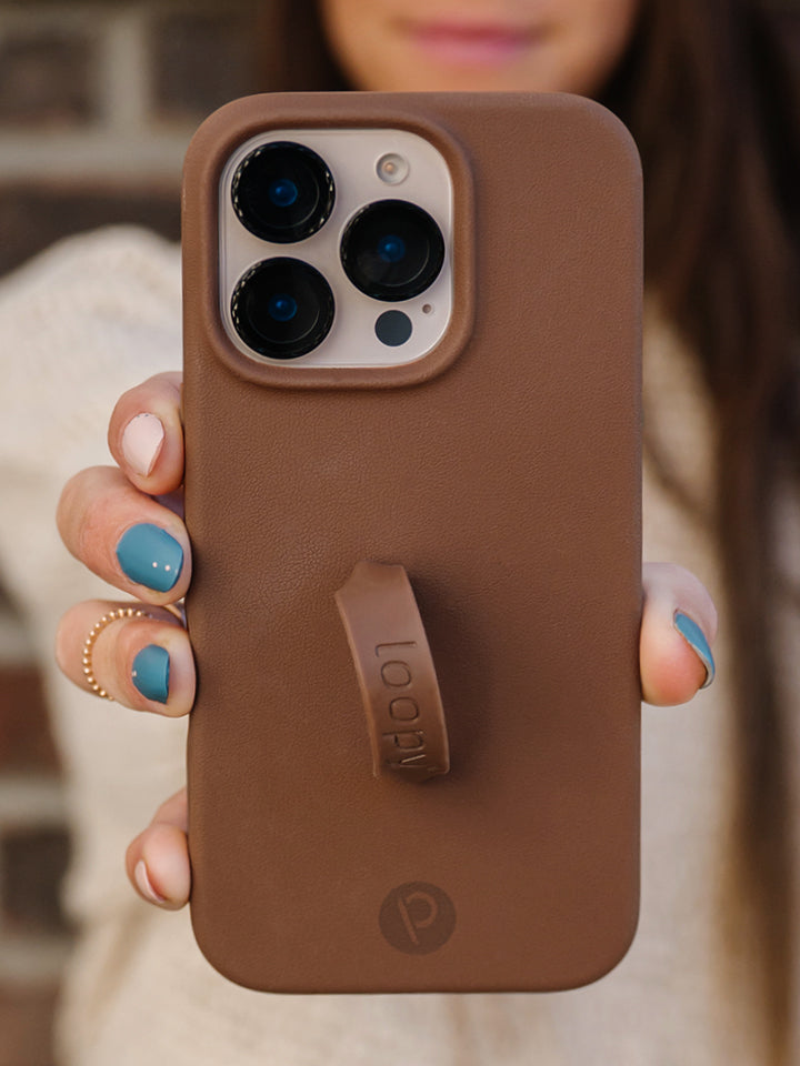 A woman holding a Cappuccino Loopy Case. || feature-media