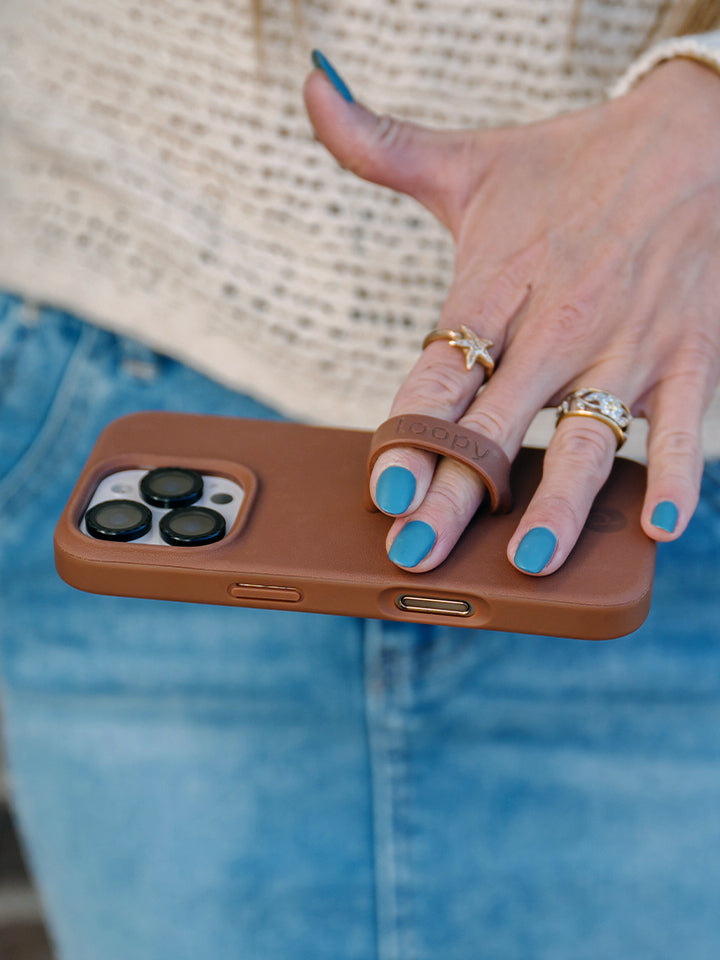 A woman holding a Cappuccino Loopy Case. || feature-media