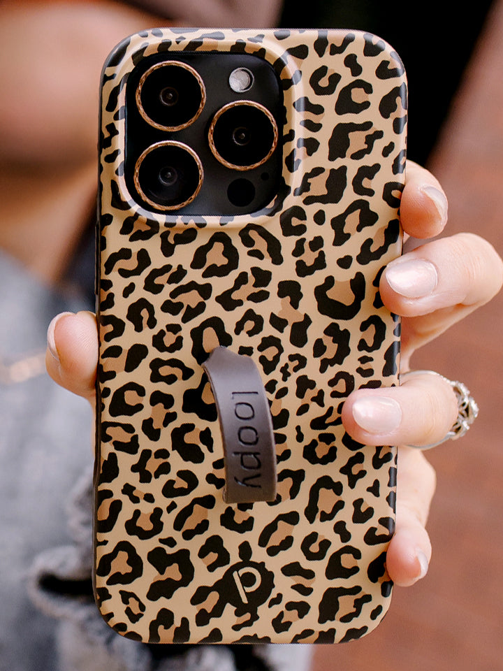 A woman holding a Cheetah Loopy Case. || feature-media