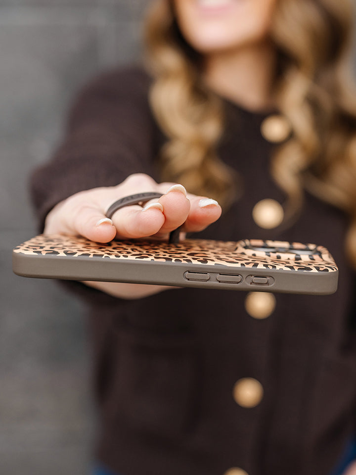 A woman holding a Cheetah Loopy Case. || feature-media