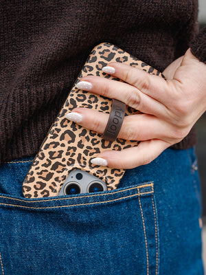 A woman holding a Cheetah Loopy Case. || feature-media