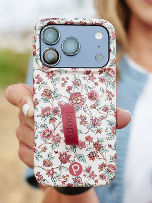 A woman holding a Chloe Floral Loopy Case. || feature-media