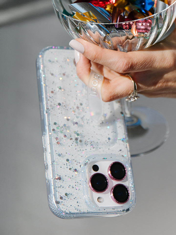 A woman holding a Cosmic Confetti Loopy Case. || feature-media