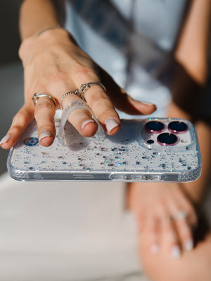 A woman holding a Cosmic Confetti Loopy Case. || feature-media