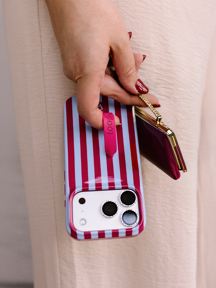 A woman holding a Cranberry Stripes Loopy Case. || feature-media