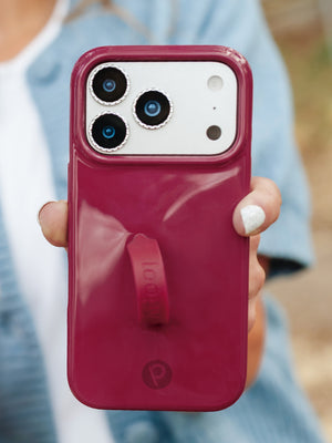 A woman holding a Dark Cherry Loopy Case. || feature-media