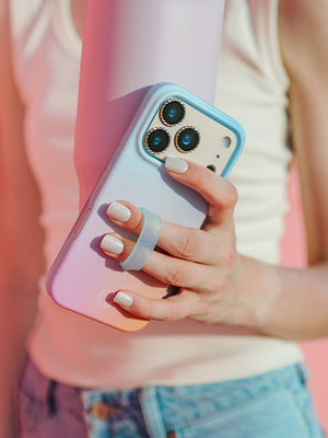 A woman holding a Daydream Blur Loopy Case. || feature-media