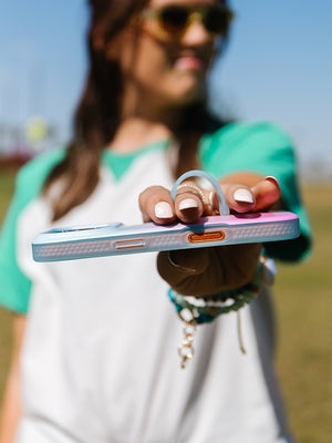 A woman holding a Daydream Blur Loopy Case. || feature-media