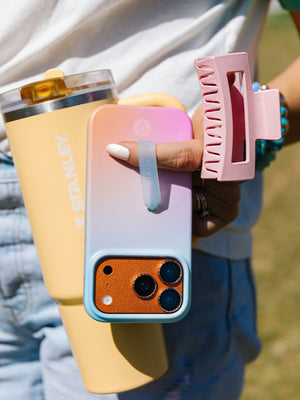 A woman holding a Daydream Blur Loopy Case. || feature-media