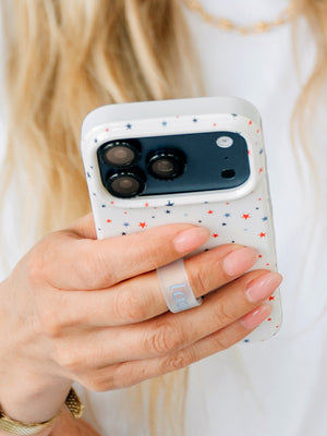 A woman holding a Freedom Stars Loopy Case. || feature-media