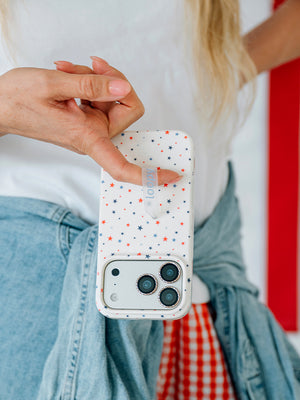 A woman holding a Freedom Stars Loopy Case. || feature-media