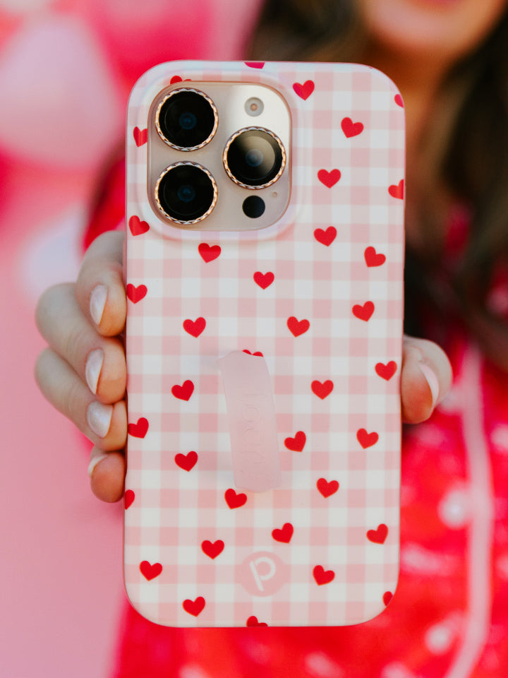 A woman holding a Galentine's Gingham Loopy Case. || feature-media