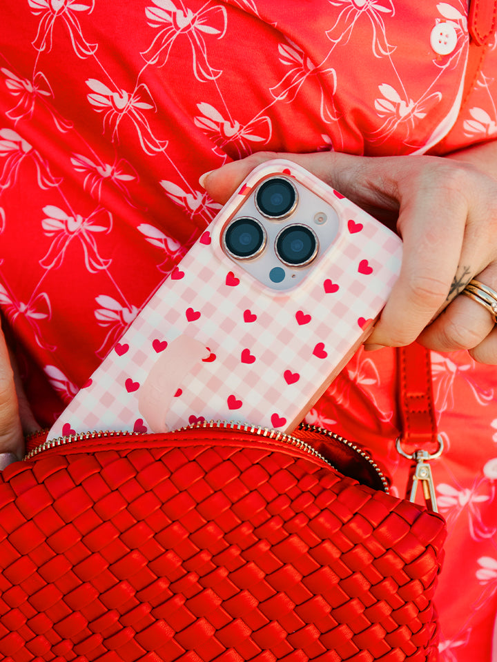 A woman holding a Galentine's Gingham Loopy Case. || feature-media